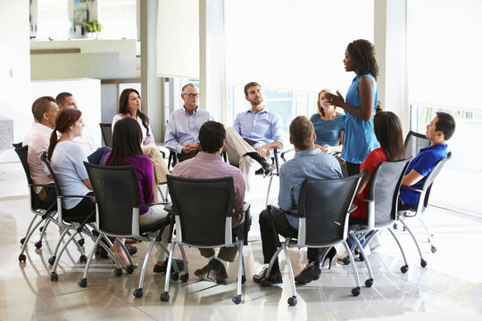 Business woman Addressing Multi-Cultural Office Staff Meeting