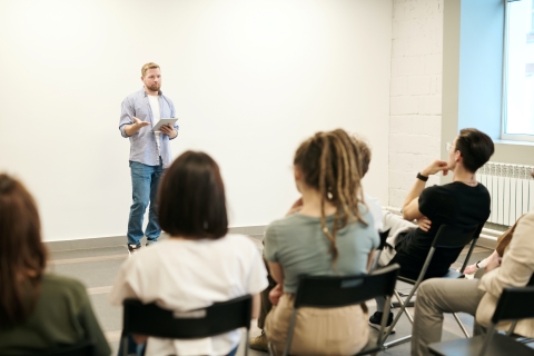 Person presenting at the front of a room